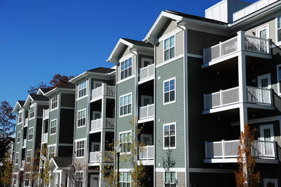 Four-story apartment building with gabled roofs.